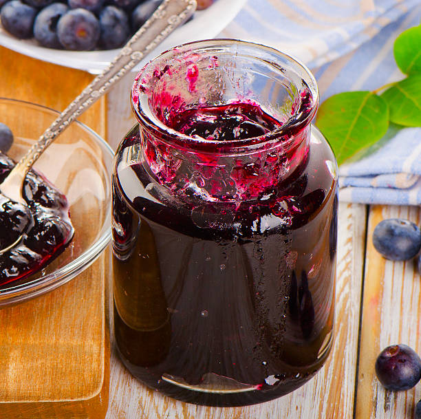 Fresh blueberries jam  in a glass jar.