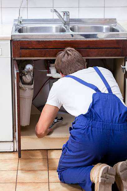 istock Handyman fixing sink in the kitchen 521346267
