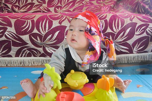 Asian Baby Boy Playing And Thinking In Room Stock Photo - Download Image Now - 6-11 Months, Activity, Arts Culture and Entertainment