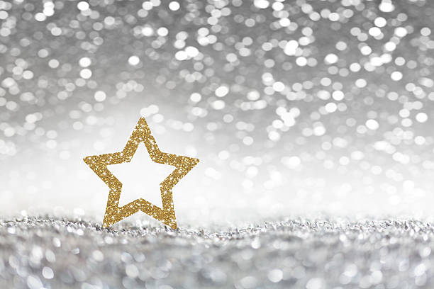 istock Christmas, golden christmas star on silver glitter background 521348051