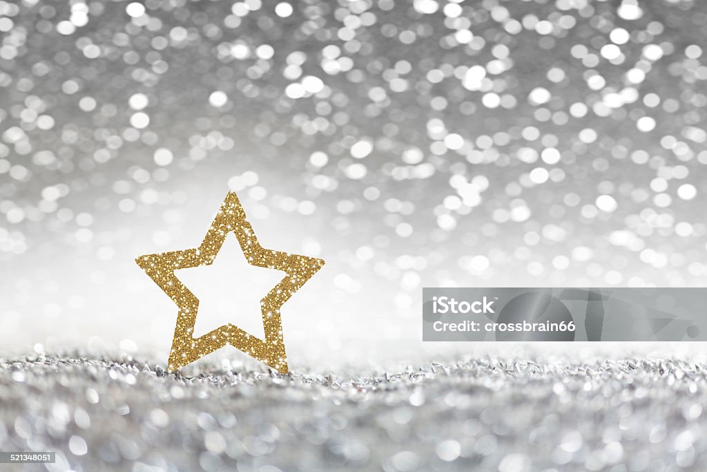 Christmas, golden christmas star on silver glitter background Christmas - Xmas concept - golden sparkling christmas star on silver glitter background Bright Stock Photo