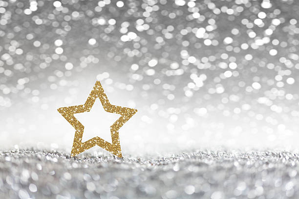 Christmas, golden christmas star on silver glitter background stock photo