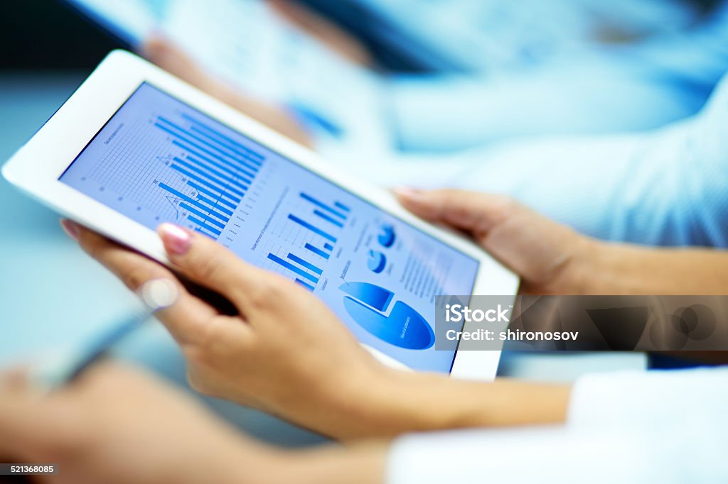 Market analysis Businesswoman hands with touchpad while learning situation on the market Analyzing Stock Photo