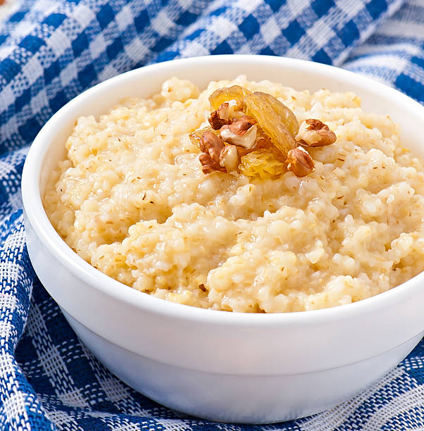 каша в миску с орехи и изюм - oatmeal porridge oat raisin стоковые фото и изображения