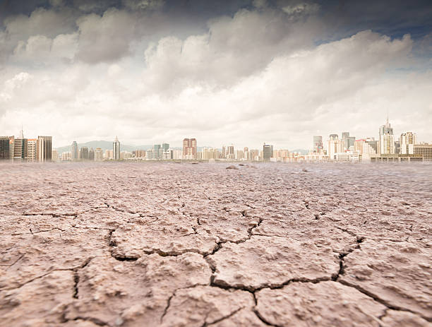 istock city looks over a cracked earth landscape 521369367