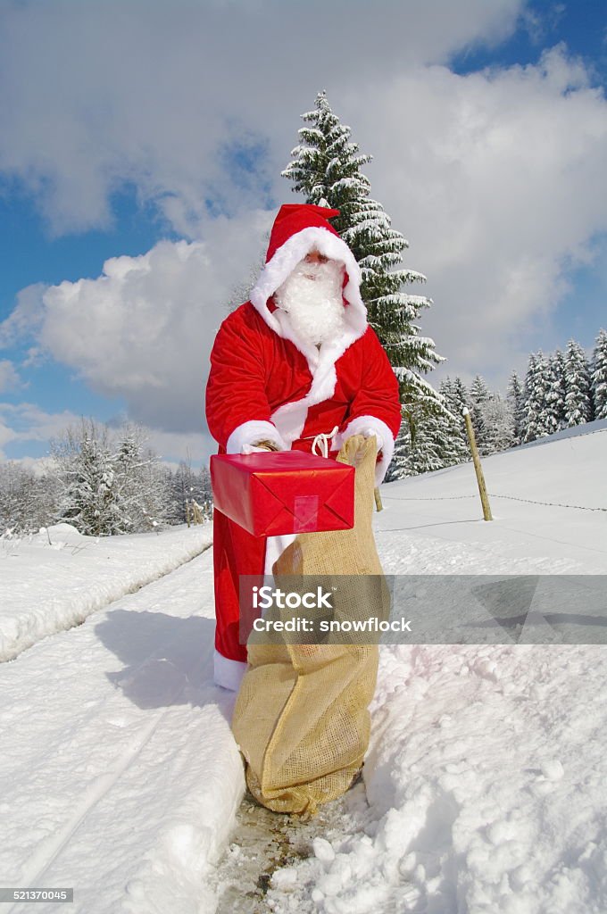 Santa Claus Santa Claus, Father Christmas holds red present Adult Stock Photo