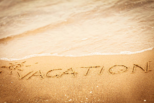istock The word vacation written in the sand on a beach 521370171