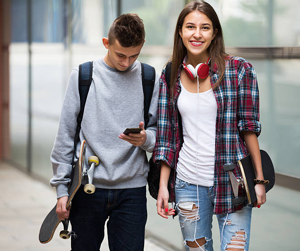 istock Teenagers with skateboards walking 521374890