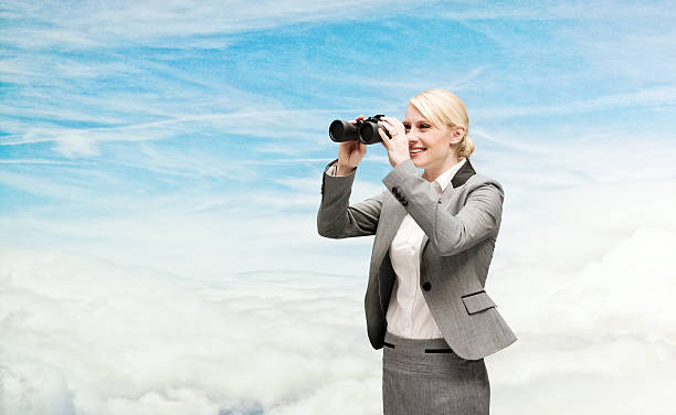istock Businesswoman looking through binocular 521374920