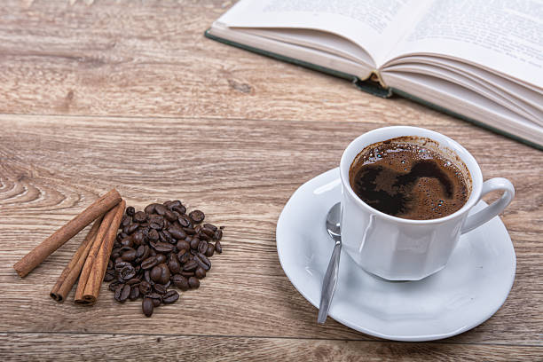 istock A cup of coffee with a book on a wooden background 521376230