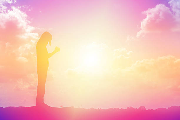 istock silhouette of a young woman standing alone 521377006