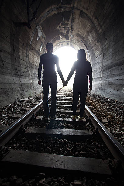 istock Couple walking together through a railway tunnel 521377502