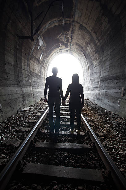 istock Couple walking together through a railway tunnel 521379598