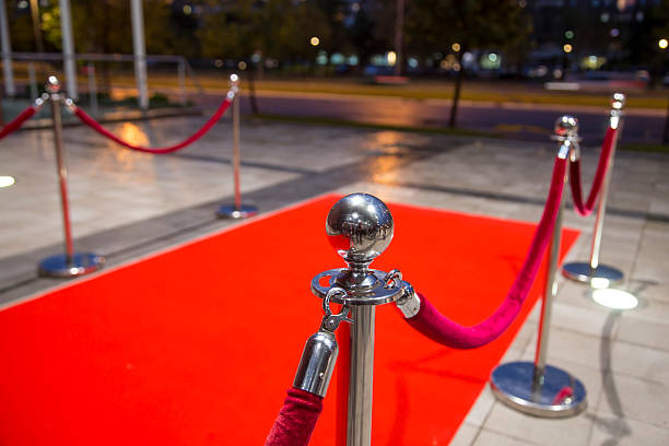 Red carpet Red carpet between two rope barriers. roped off stock pictures, royalty-free photos & images