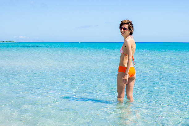 Happy woman bathing in a clear sea