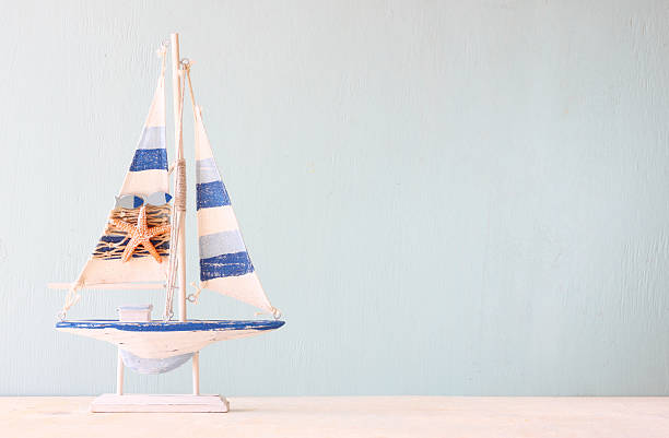 istock wooden boat over wooden textured background. filtered image. 521380774