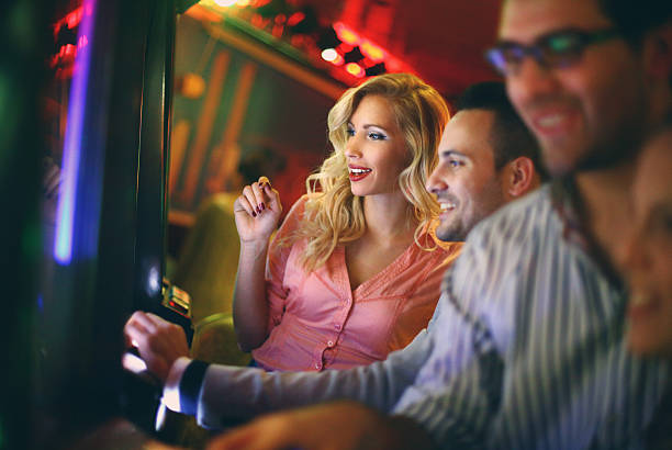 istock Group of people playing slots in casino. 521381993