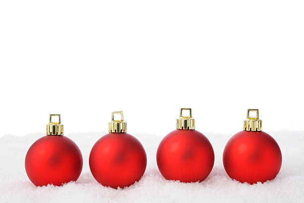 istock Four red Christmas balls on the snow with copy space 521382461