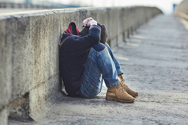 istock young homeless boy sleeping on the bridge 521382532