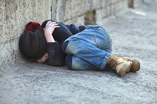 istock young homeless boy sleeping on the bridge 521382538