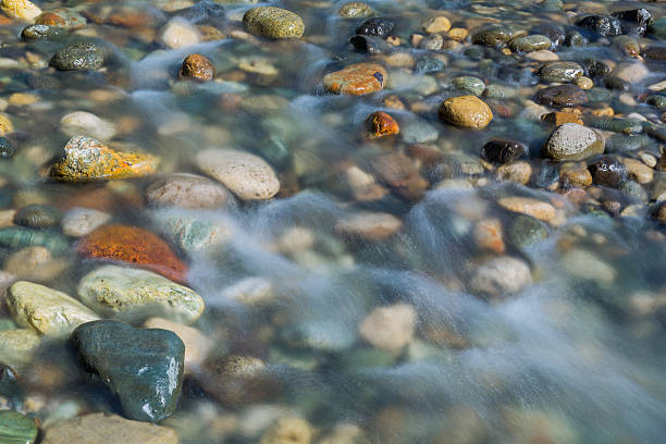 istock Pebble stones in the river water close up view, 521382672