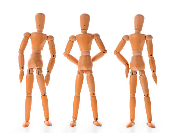 istock Three wooden dolls in different poses 521382818