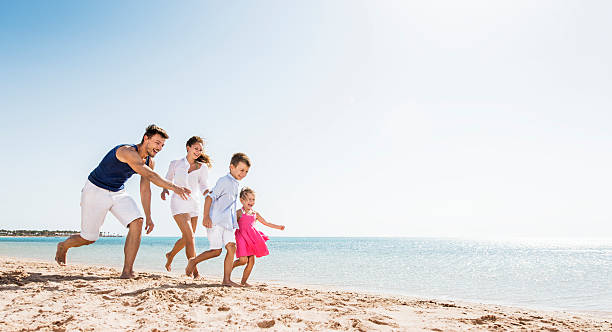 istock Young playful family at the beach. 521383367