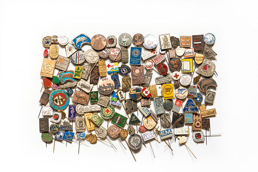 Button Badge Collection - from some ten years ago made of metal. White background.