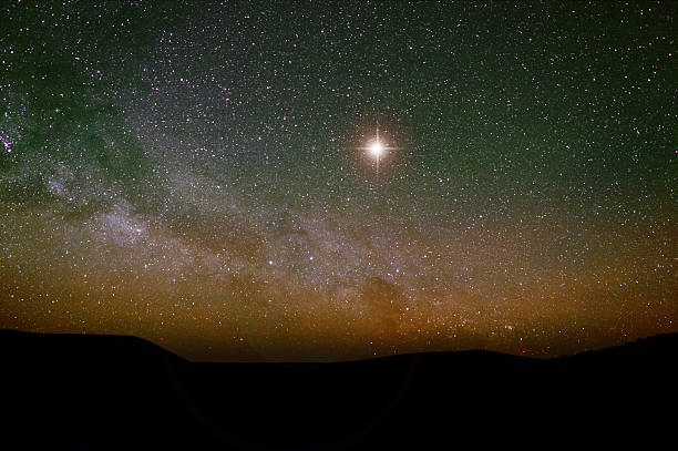 Nativity backdrop with Christmas star and real night sky. A realistic, astronomical background for a Christmas, nativity scene, especially a silhouette. The Milky Way curves towards the left. The star is artificial but realistic with lens flare. west bank photos stock pictures, royalty-free photos & images