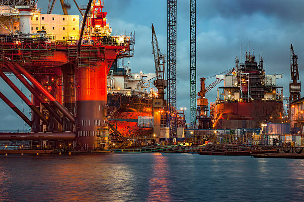 Shipyard at dusk Shipyard industry - Oil Rig under construction in Gdansk, Poland. gdansk photos stock pictures, royalty-free photos & images
