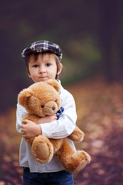 istock Little boy with suitcase and teddy bear 521384267