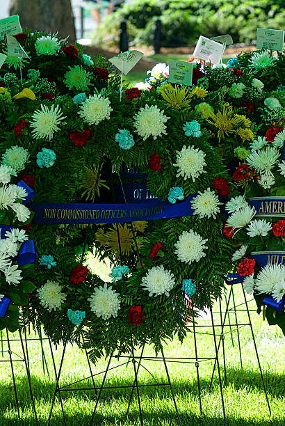 Wreath, Arlington National Cemetery Arlington, Virginia, USA - May 24, 2015: A fresh wreath is ready to be placed at the Tomb of the Unknown Soldier for Memorial Day events at Arlington National Cemetery. arlington cemetery in spring stock pictures, royalty-free photos & images