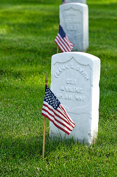 Tombstone, U.S. Flag, Arlington National Cemetery, Close-up Arlington, Virginia, USA - May 24, 2015: Small U.S. flags are placed in front of every tombstone each Memorial Day at Arlington National Cemetery, including these from the Spanish-American War. arlington cemetery in spring stock pictures, royalty-free photos & images
