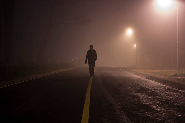 istock Man standing on street with Fog 521385281