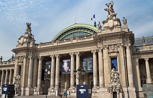 Paris, France - June 11, 2014: The Grand Palais. The Grand Palais shows art exhibitions and hosts different cultural events, attracting over 2 million people each year. People are standing near museum.