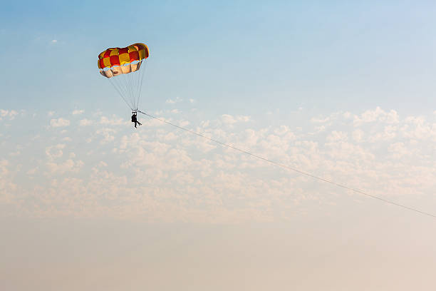 istock Man parasailing over the sea 521385674