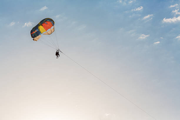 istock Man parasailing over the sea 521385714