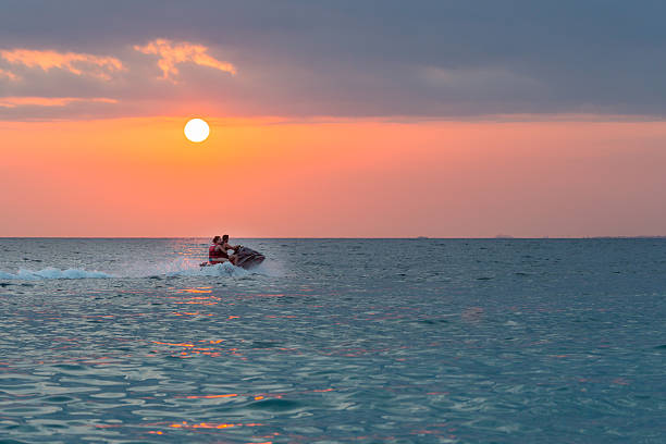 istock Couple riding jet ski 521385908