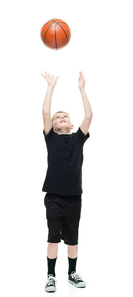 istock Smiling little boy playing with basketball 521385938