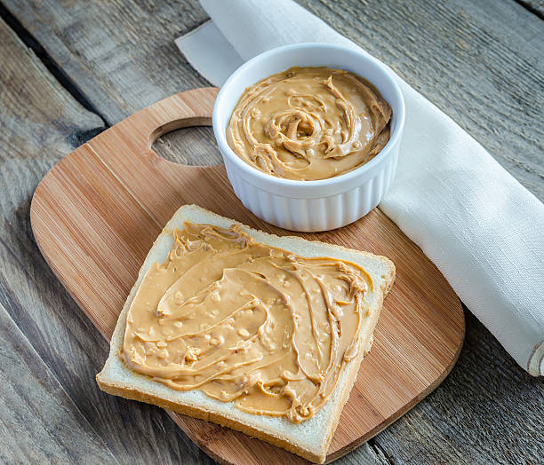 istock Sandwich with peanut butter on the wooden board 521386629