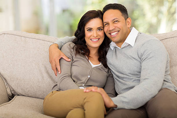 istock couple sitting on sofa at home 521387917