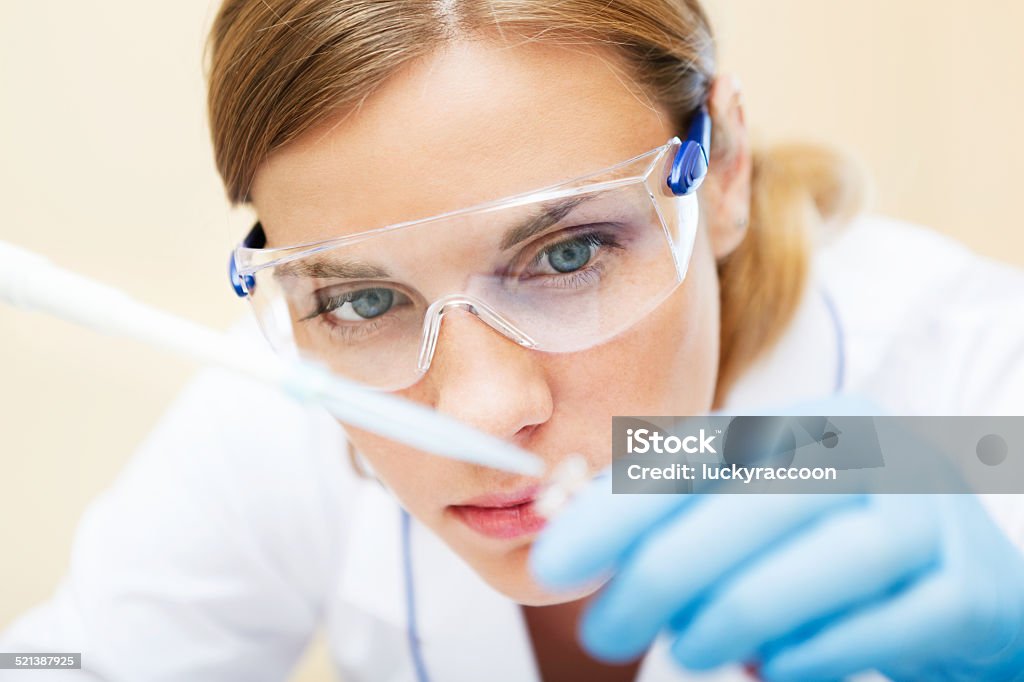 Young scientist working with samples in lab. Young beautiful scientist working with samples in lab. Adult Stock Photo