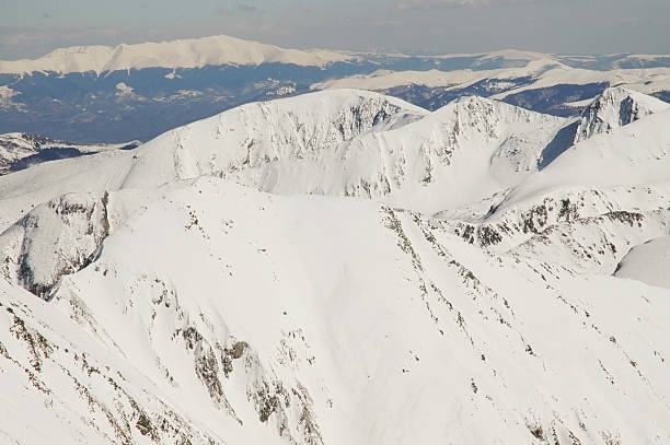 istock Snow covered mountains in a sunny day 521388317