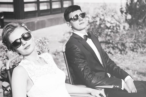 istock trendy bride and groom in sun glasses 521398663