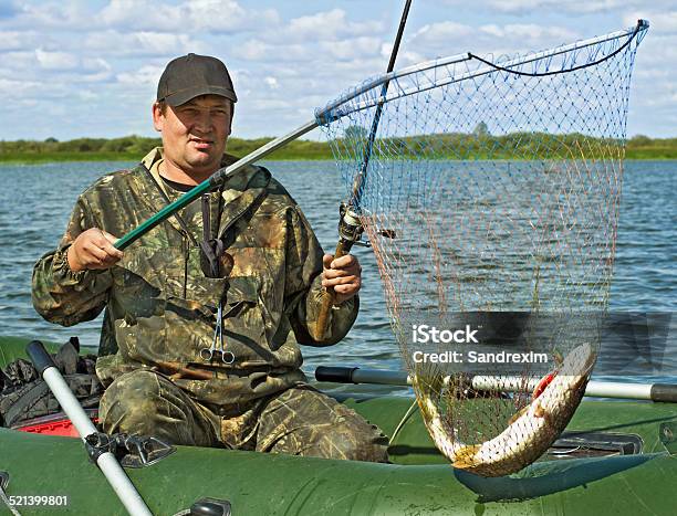 The Fisherman Caught A Pike Stock Photo - Download Image Now - Catching, Fish, Nautical Vessel