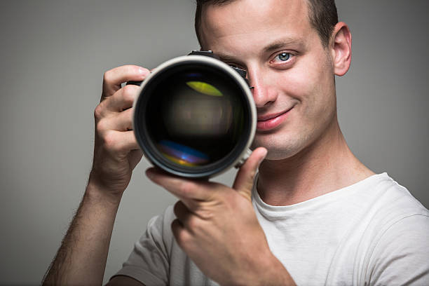 istock Young pro photographer with digital camera 521399889
