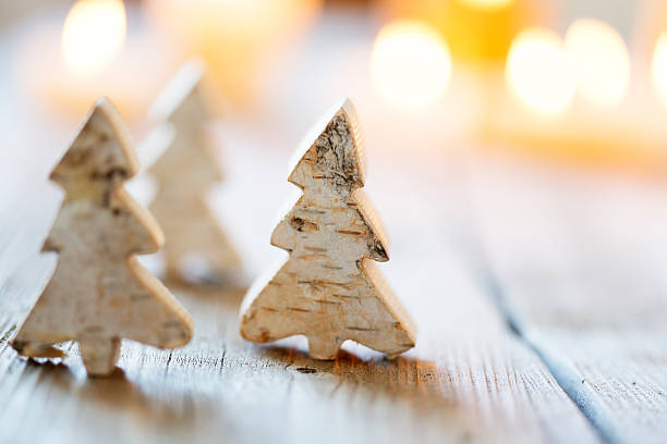istock christmas tree and candle light on rustic wood 521402413