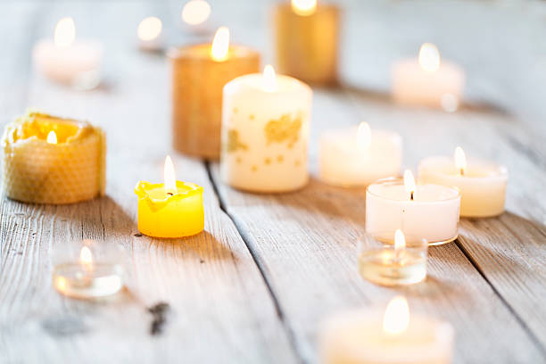 istock christmas candle light on rustic wood 521402423