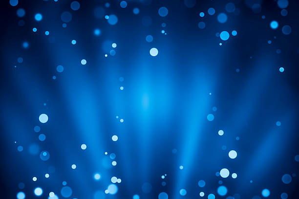 Blue rays of light with bubbles and glitters stock photo