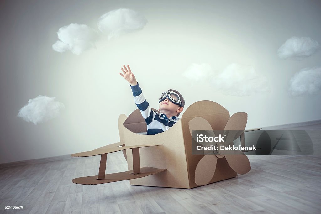 Dreams Little boy in a cardboard airplane Cardboard Stock Photo